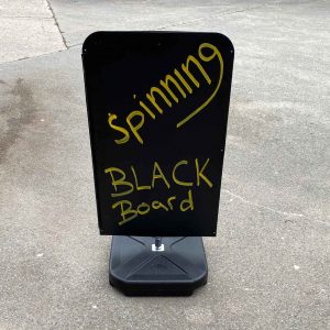 spinning black board sign