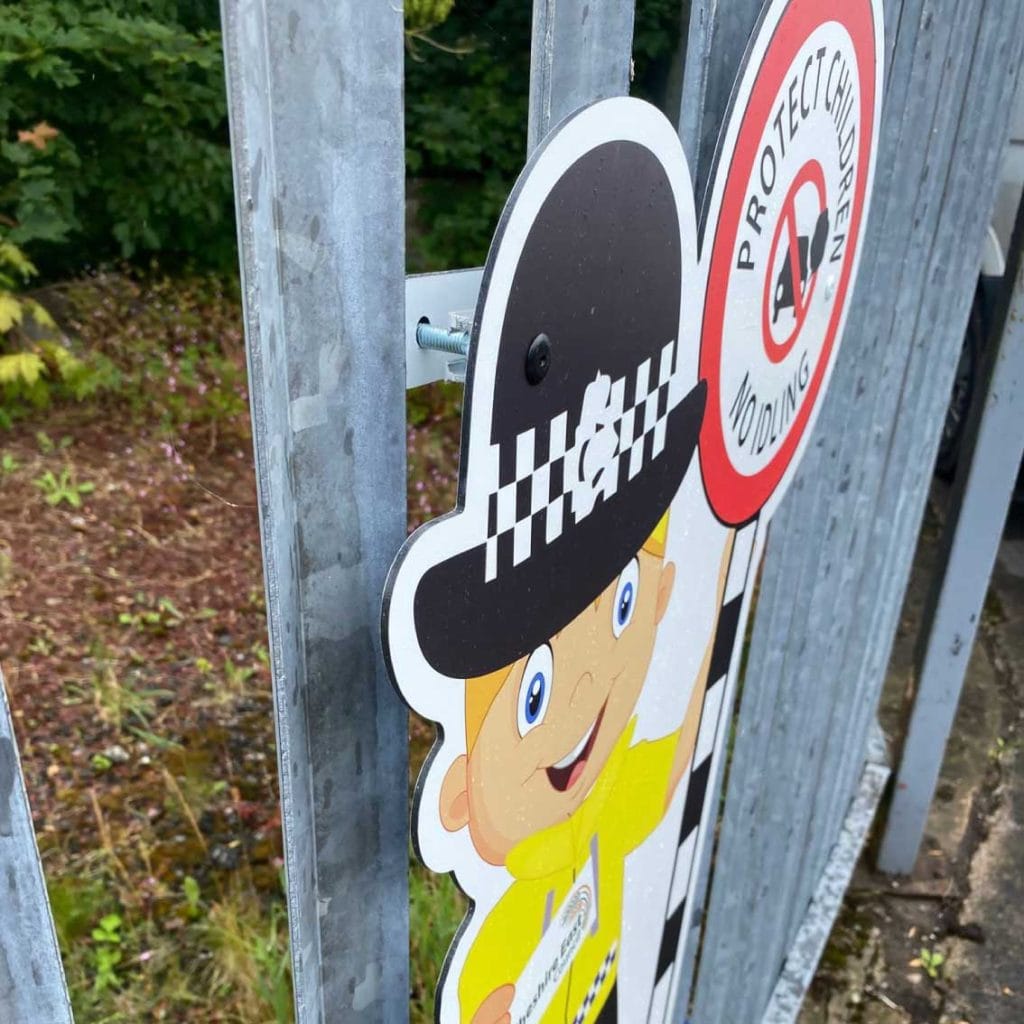 Police lady School-no-idling-protect-children-fence-sign